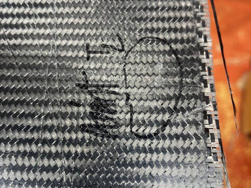 Carbon fiber test coupon annotated with numbered impact strike locations