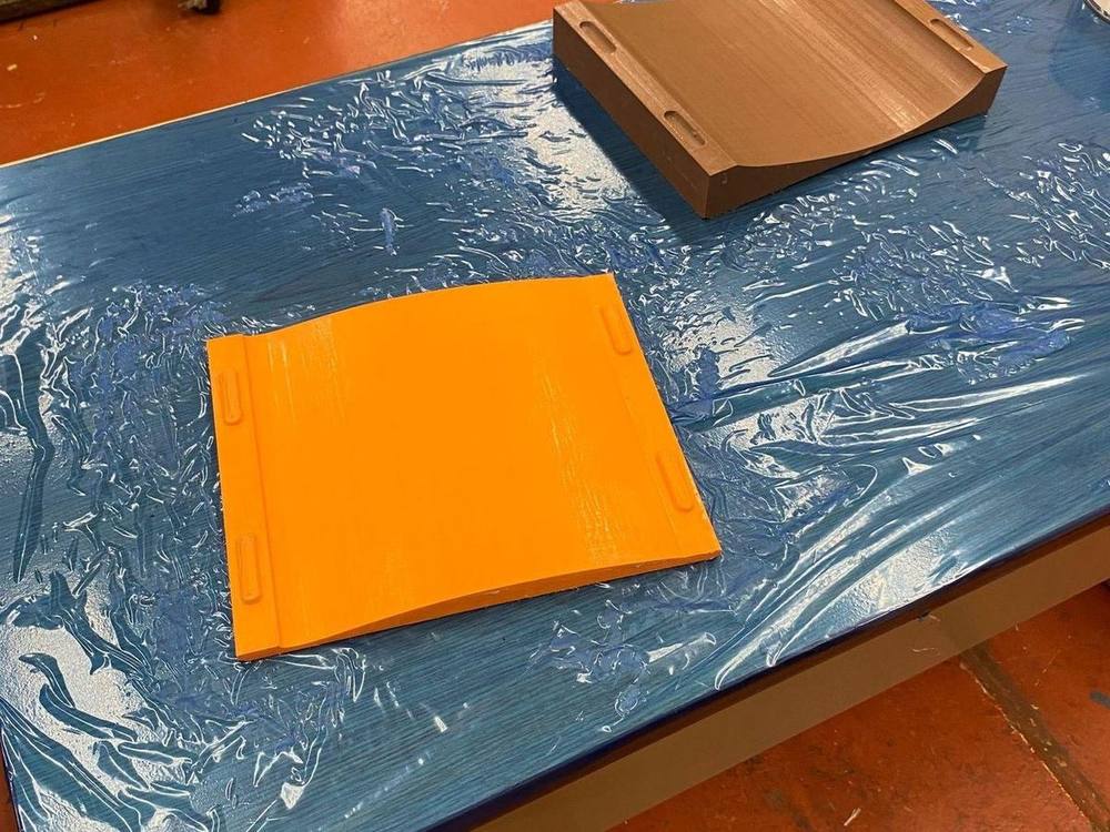Demolded carbon fiber wing section held in hand