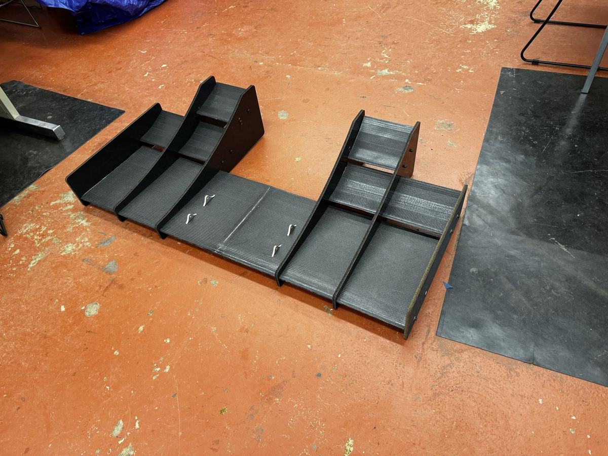 Front wing elements and endplates laid out on the shop floor