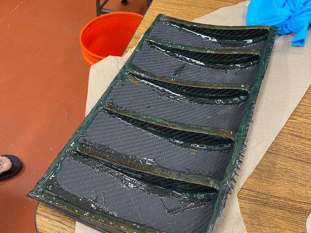Cured wing sections laid out on the bench