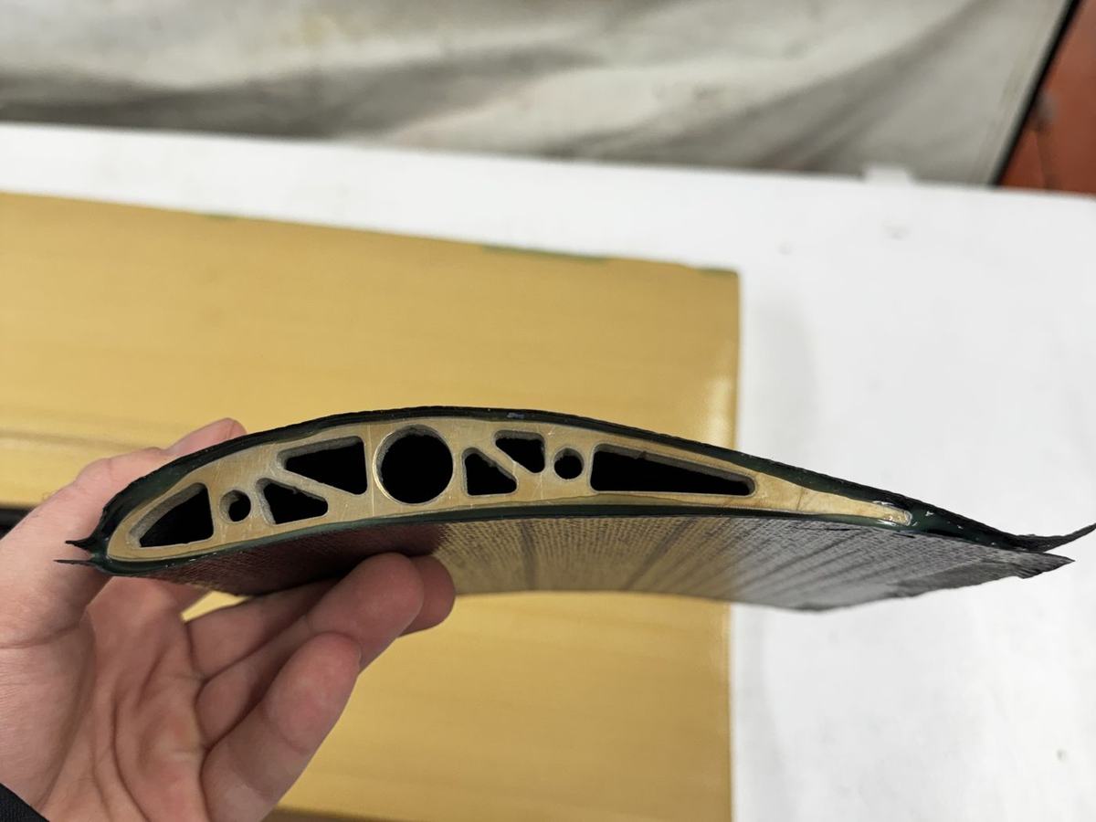 Carbon fiber internal rib with lightening holes held in hand