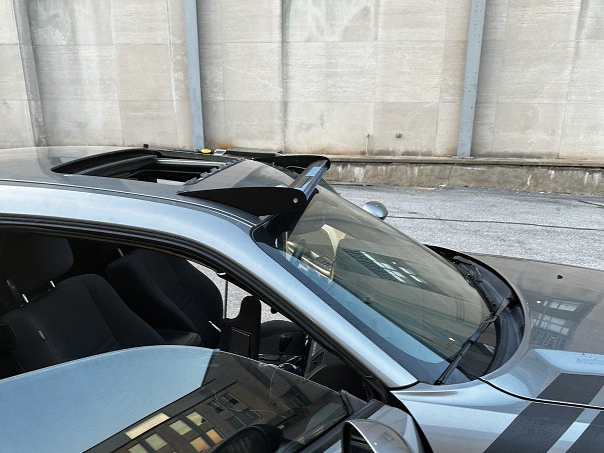 Custom roof brackets holding the light bar, freshly mounted, moonroof open below
