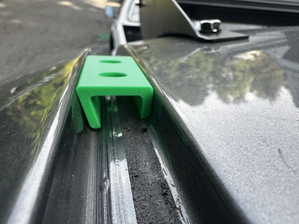 3D-printed prototype bracket seated in the rain gutter channel to verify the modelled geometry