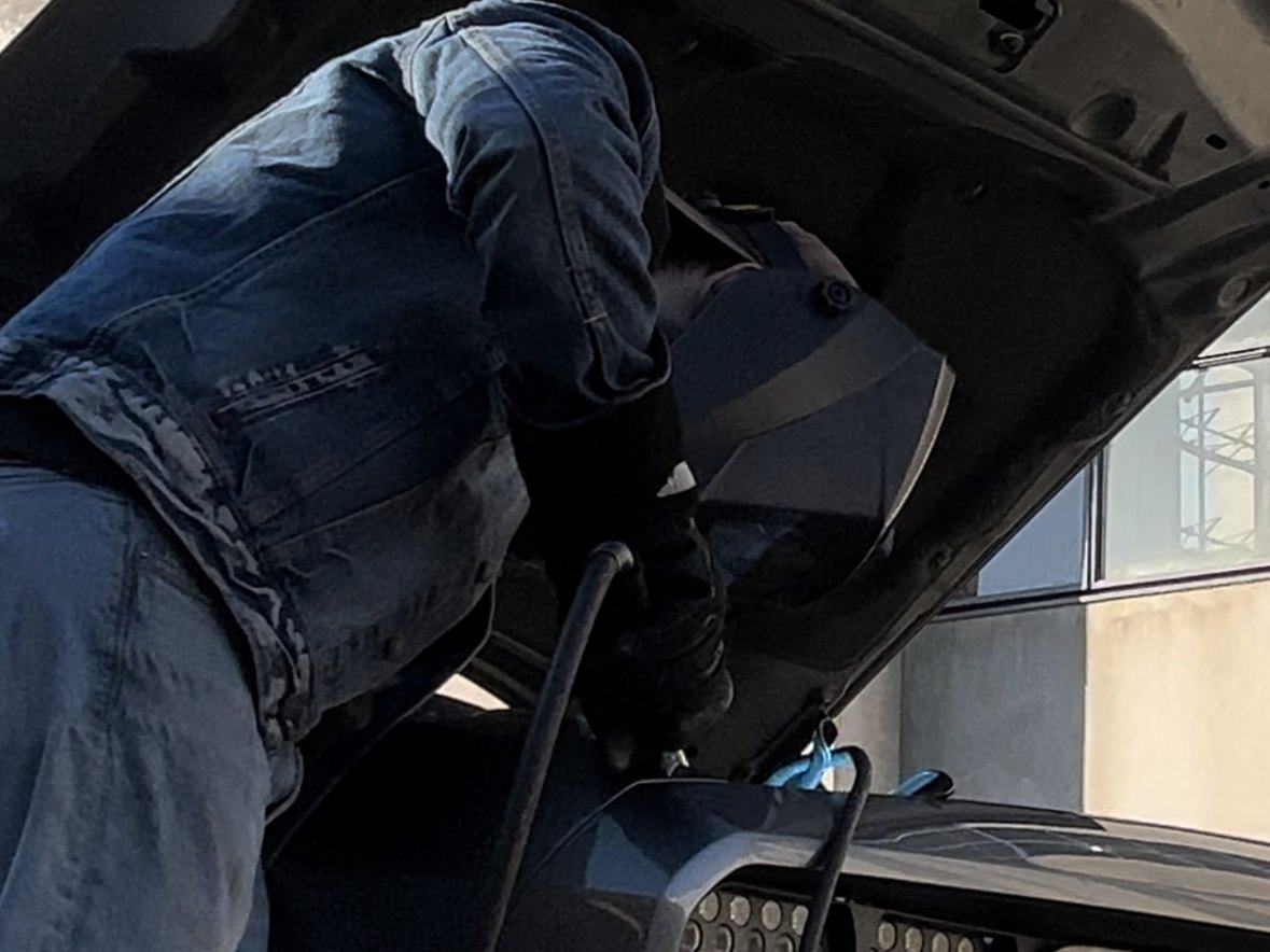 Welding the headlight assemblies together under the raised hood