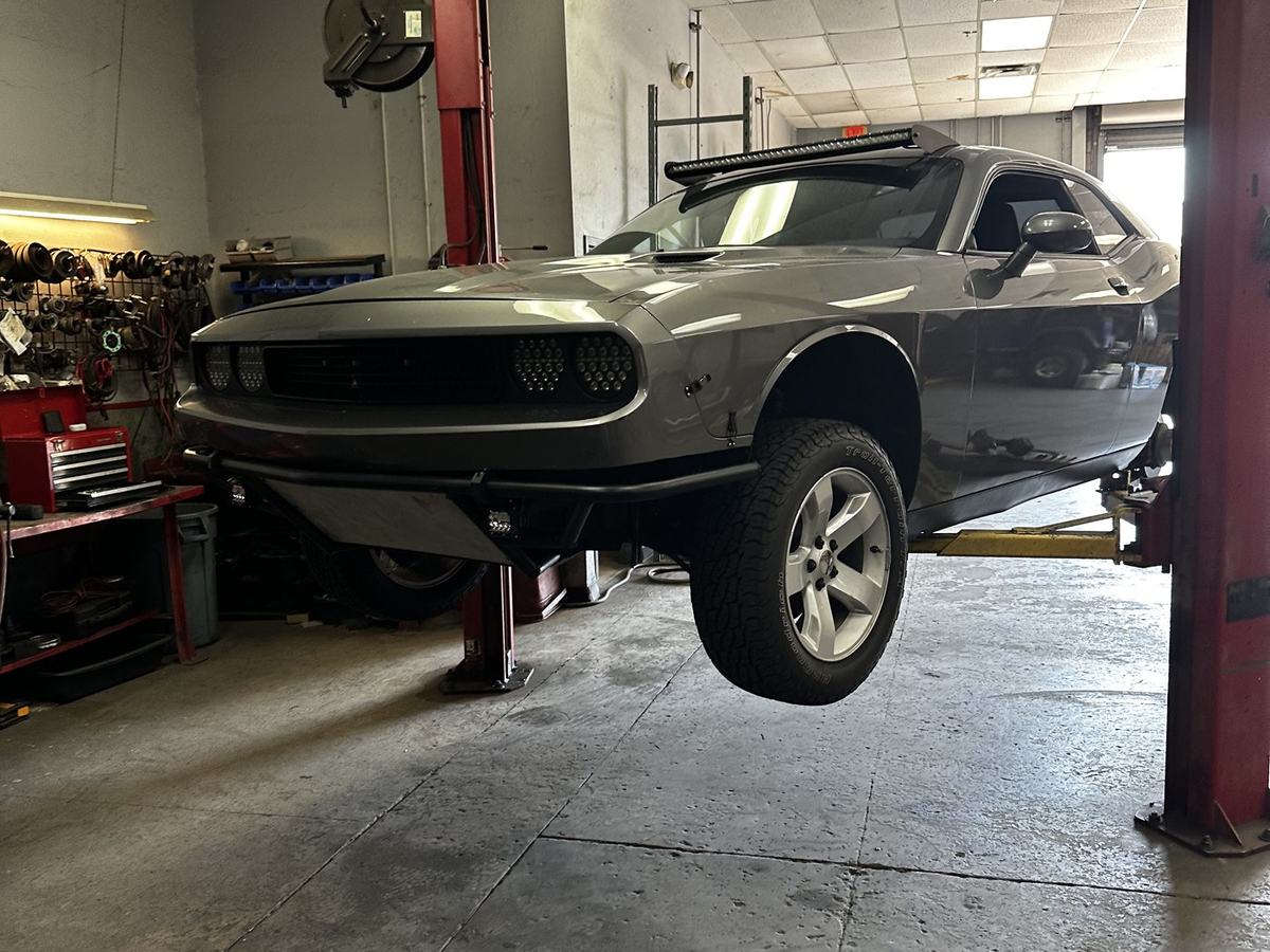 The Challenger raised on a two-post lift in the shop
