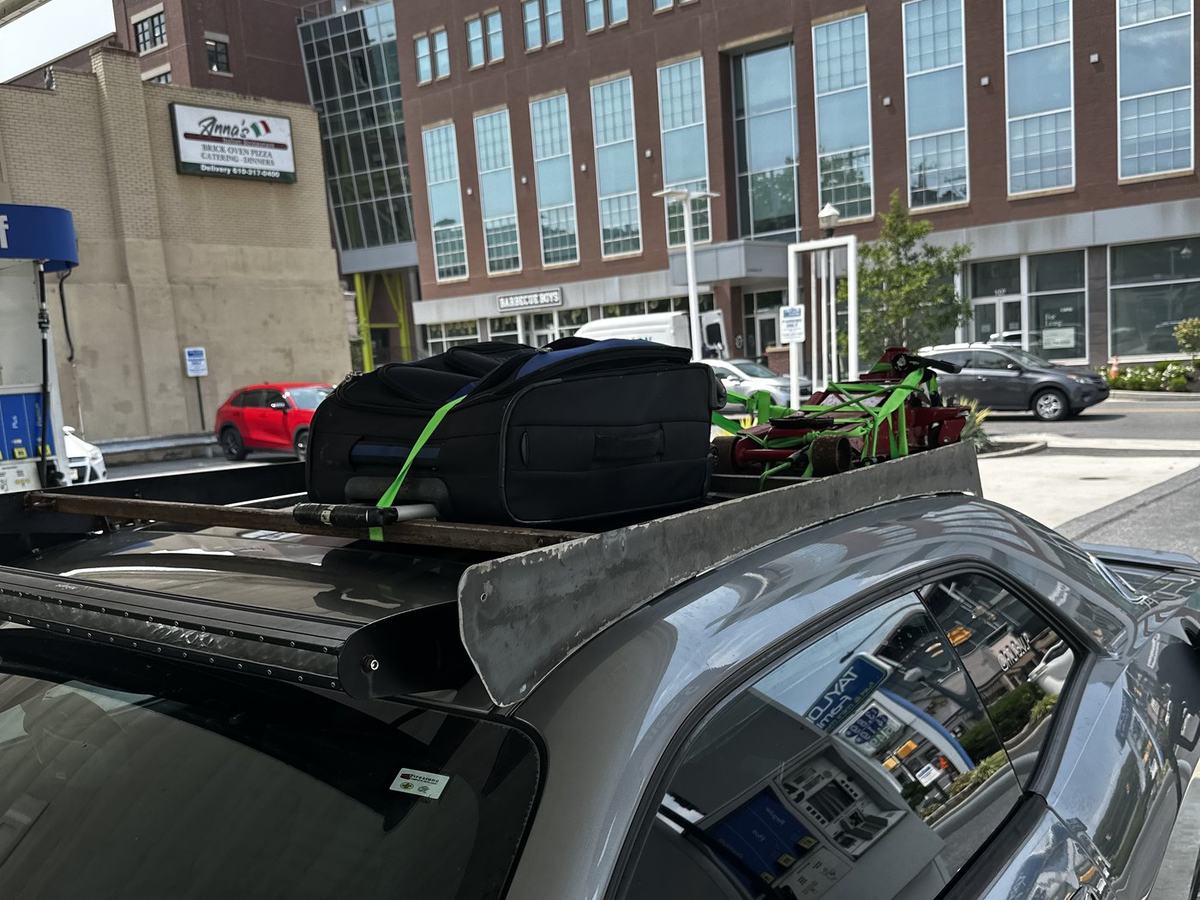The fabricated roof rack bolted to the brackets and loaded with gear before the cross-country drive