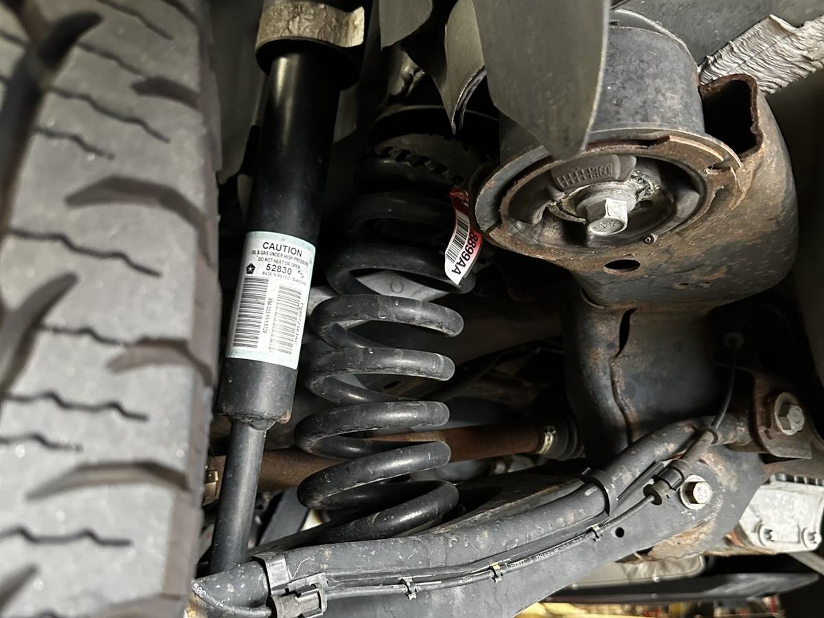 Rear suspension with the lift spacer installed on top of the coil spring
