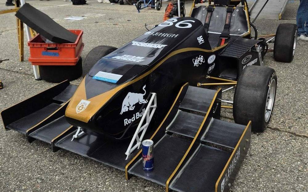 The completed Formula SAE car at competition in the black, gold and silver livery