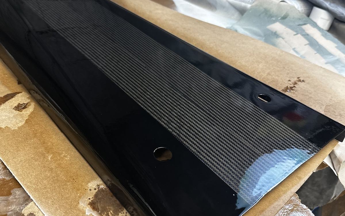 Carbon body panel painted, wet sanded and clear coated to a mirror finish