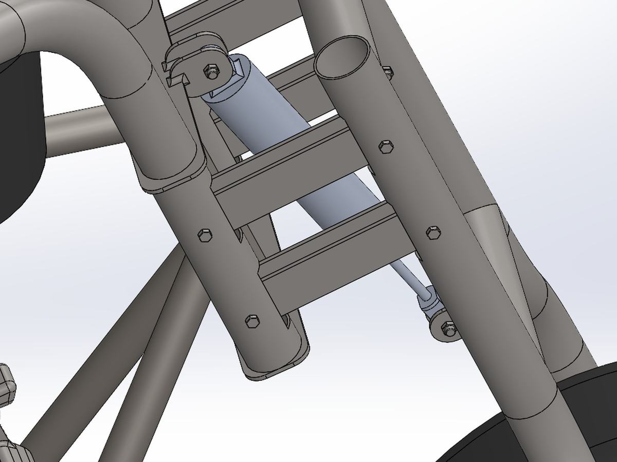 CAD detail of the front four-link suspension with a coilover shock between the fork tubes