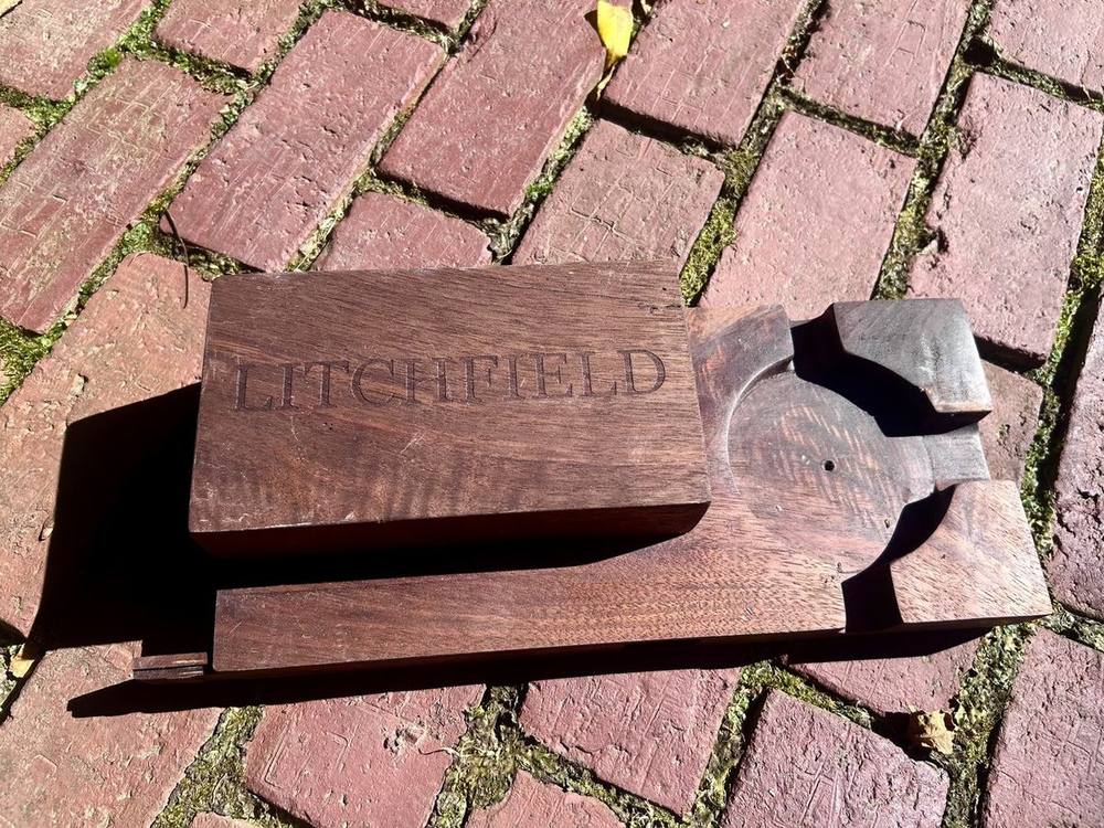 Walnut cigar box closed, with the sliding lid laser engraved LITCHFIELD