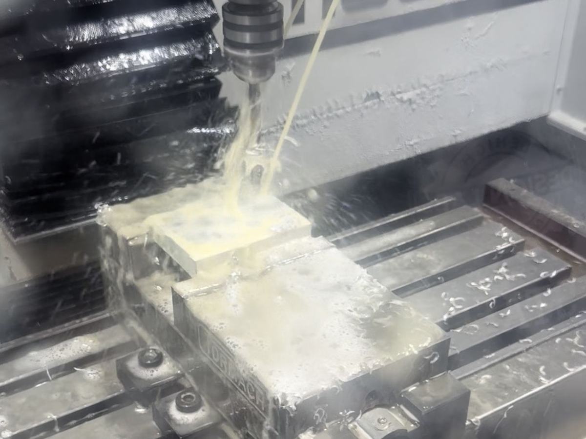 Aluminum part being machined on the CNC mill under coolant